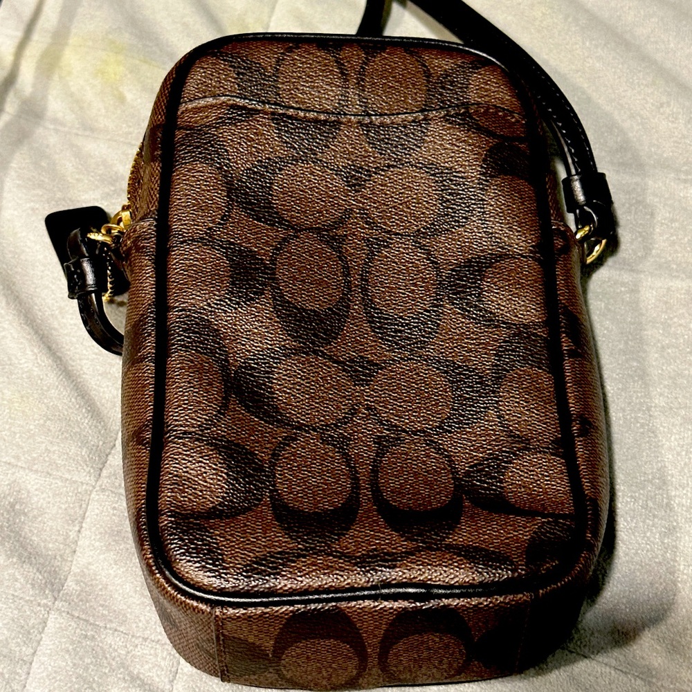 COACH Signature crossbody. Inside card compartments with gold accents.